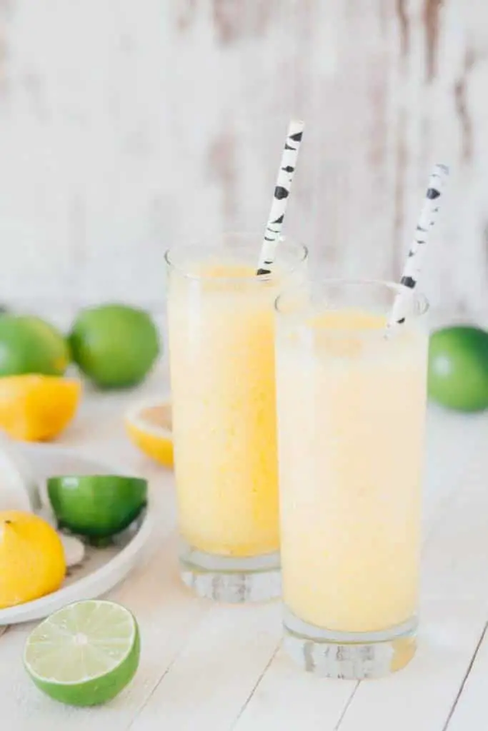 yellow drink with paper straw lemons and limes unsplash stock