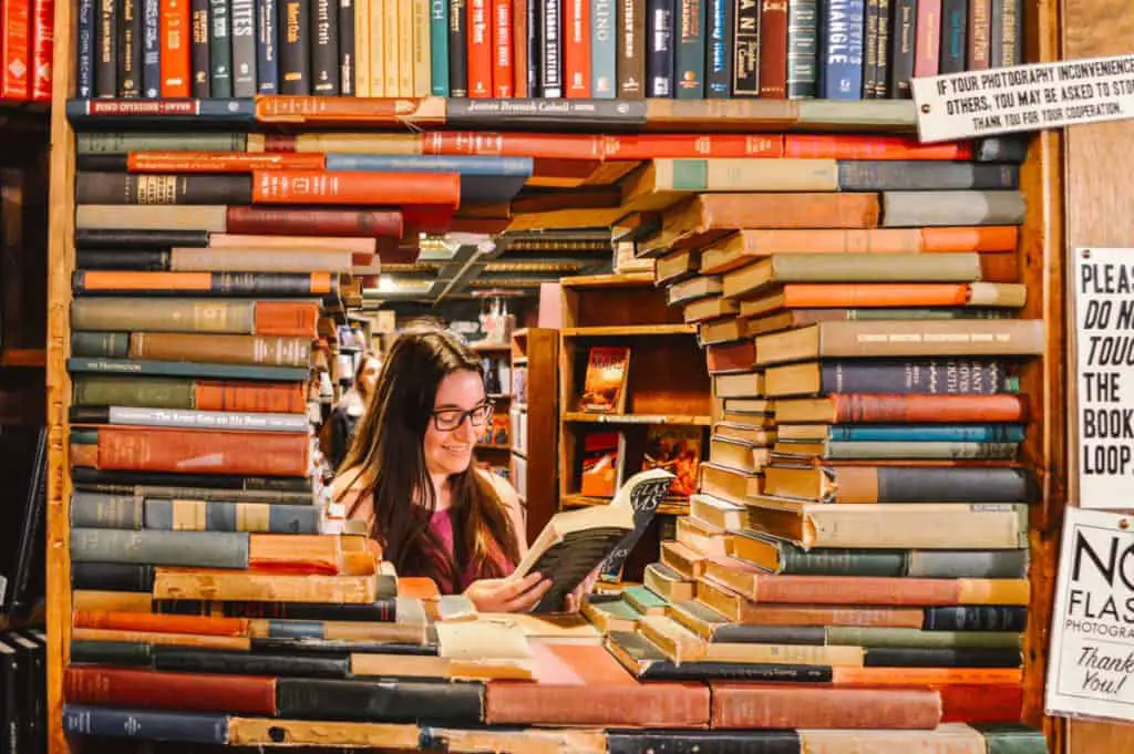 books piled high with window in the middle