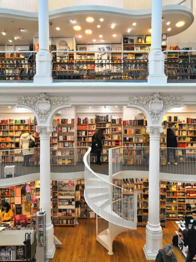multiple story bookstore with white staircase through the middle