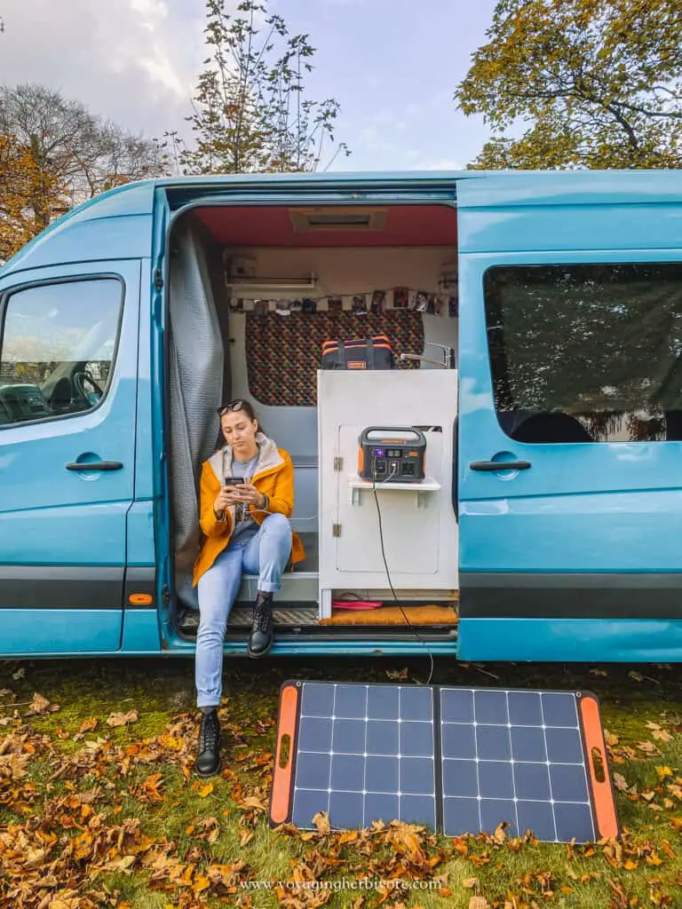 uk van life travel girl charing phone with the jackery 500 uk and solar saga