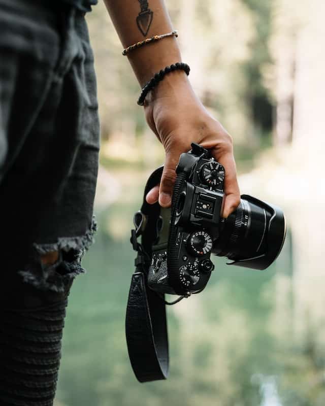 person holds camera